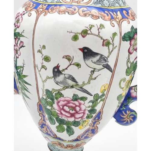 613 - An antique Chinese enamel large coffee pot. 28cm tall. 26cm wide.