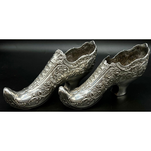 662 - An early Victorian pair of white metal shoes. Total weight: 706 grams.  19cm length. 10cm tall.