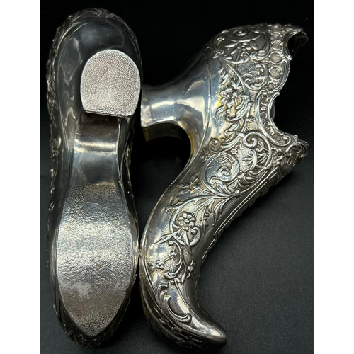 662 - An early Victorian pair of white metal shoes. Total weight: 706 grams.  19cm length. 10cm tall.