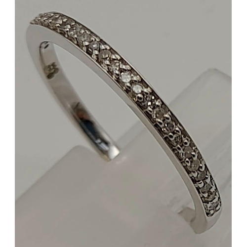 262 - A 9 K white gold, half eternity diamond (0.10 carats) ring. Ring size: N, weight: 1.6 g.