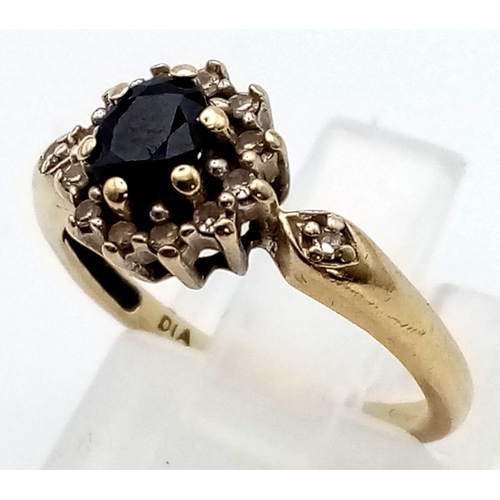 283 - A 9 K yellow gold ring with an oval cut sapphire surrounded by a halo of diamonds. Ring size: J weig... 