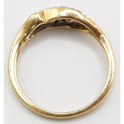 333 - A 9 K yellow gold ring a couple of twisted diamond bands on top. Ring size: M1/2, weight: 2.2 g.