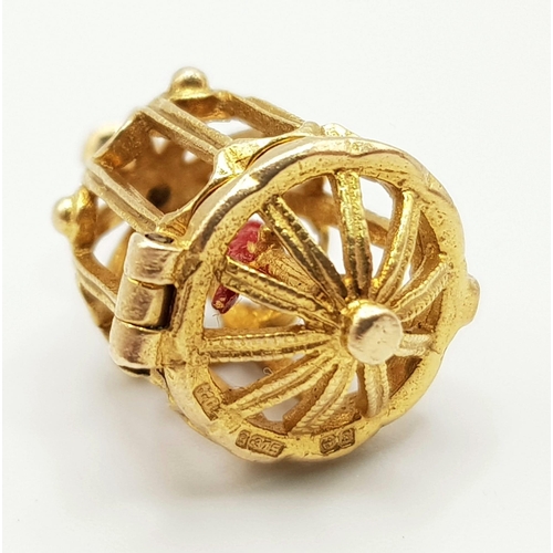 346 - A 9 K yellow gold bird cage charm, which opens to reveal a red enamelled exotic bird. Height: 20 mm,... 