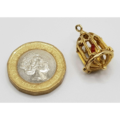 346 - A 9 K yellow gold bird cage charm, which opens to reveal a red enamelled exotic bird. Height: 20 mm,... 