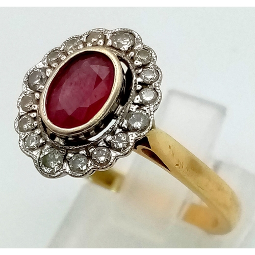 5 - An 18 K yellow gold ring with an oval cut ruby surrounded by diamonds. Ring size: R, weight: 5.4 g.