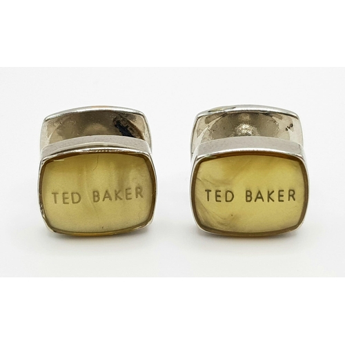 514 - A white metal (untested) TED BAKER cufflinks.