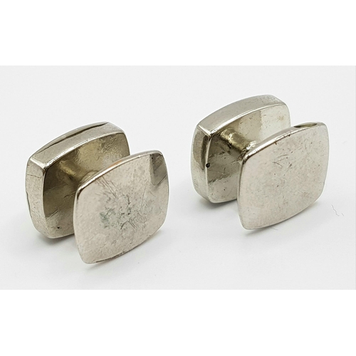 514 - A white metal (untested) TED BAKER cufflinks.