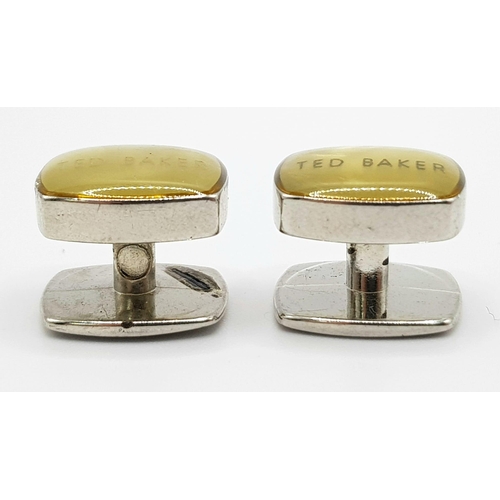 514 - A white metal (untested) TED BAKER cufflinks.