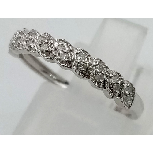 80 - A 9 K white gold ring with a band of ten diamonds (0.1 carats). Ring size: K, weight: 1.2 g.