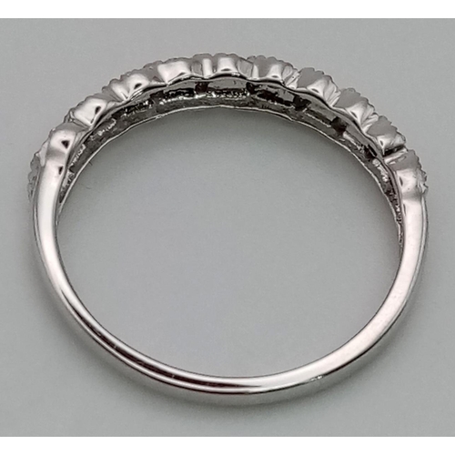 80 - A 9 K white gold ring with a band of ten diamonds (0.1 carats). Ring size: K, weight: 1.2 g.