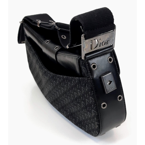 92 - A Christian Dior Columbus Shoulder Bag. Monogrammed black canvas and leather exterior. Dior metal cl... 