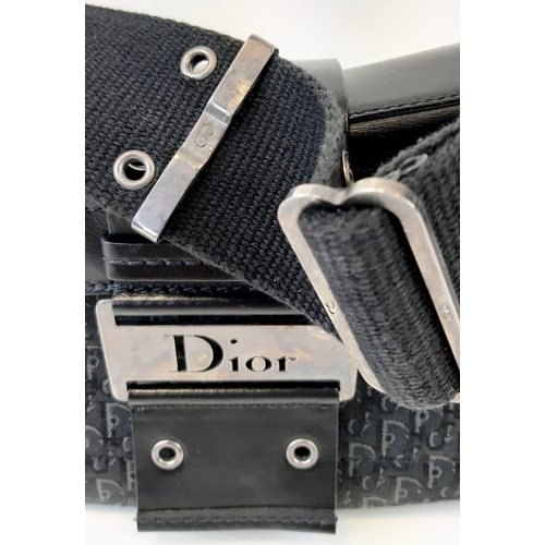 92 - A Christian Dior Columbus Shoulder Bag. Monogrammed black canvas and leather exterior. Dior metal cl... 