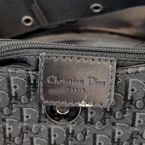 92 - A Christian Dior Columbus Shoulder Bag. Monogrammed black canvas and leather exterior. Dior metal cl... 