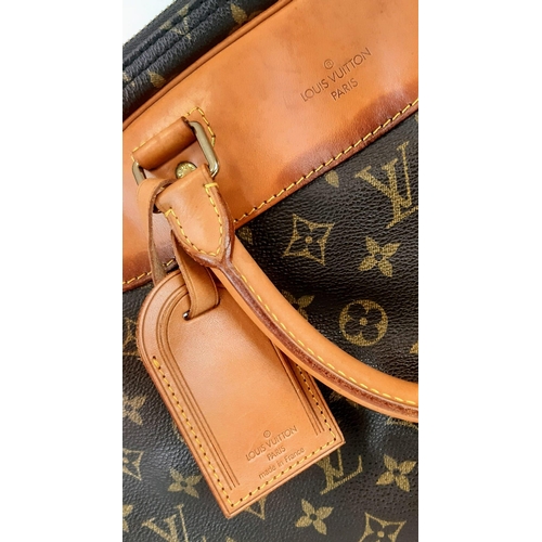 265 - A Louis Vuitton Monogram Alize 24Hr Boston Bag. Shoulder strap. Brown leather handles. Cloth interio... 