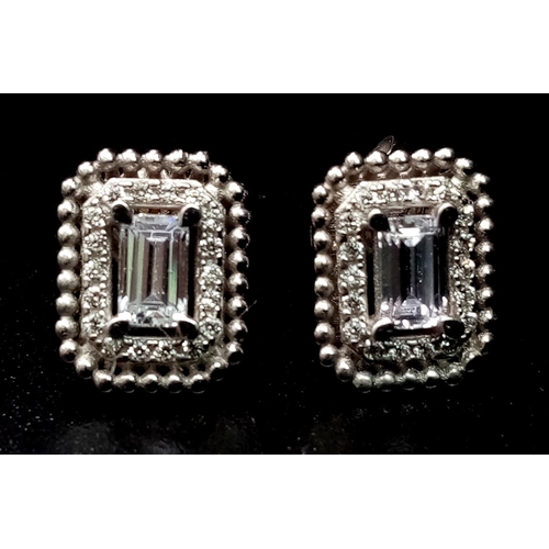 323 - A 14 K white gold, stone set pair of stud earrings. Weight: 2.8 g.