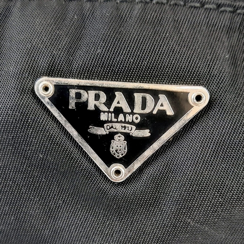 417 - Prada Nylon and Black Leather Baguette Bag. Silver-toned hardware. Monogrammed cloth interior with z... 