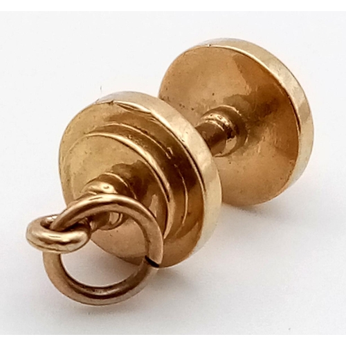 460 - An unusual, 9 K yellow gold dumbbell charm. length: 23 mm, weight: 4.7 g.