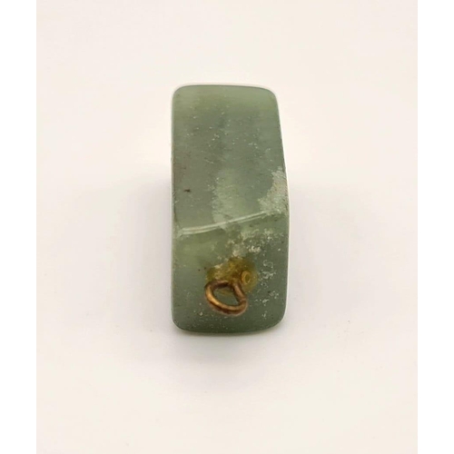 474 - A rectangular shaped jade pendant. Drop: 20 mm.