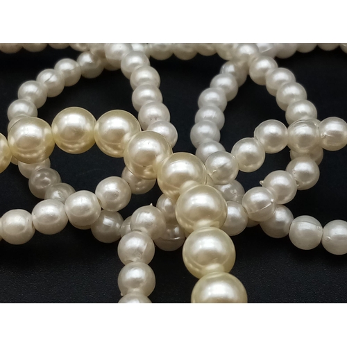 527 - A faux pearl necklace (length: 39-48 mm) AND eight expandable faux pearl bracelets.