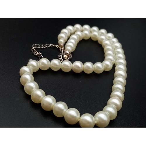 527 - A faux pearl necklace (length: 39-48 mm) AND eight expandable faux pearl bracelets.