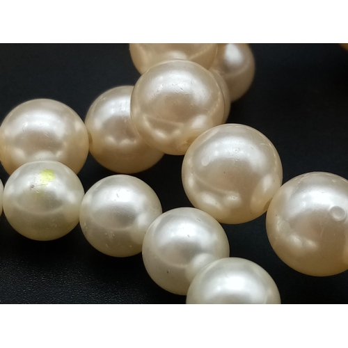 527 - A faux pearl necklace (length: 39-48 mm) AND eight expandable faux pearl bracelets.