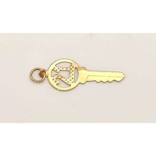 615 - 9k yellow gold 21 key charm/pendant, 25mm in length, 0.4 grams total weight