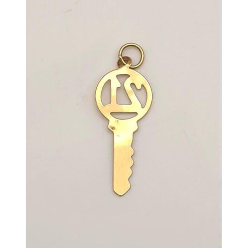 615 - 9k yellow gold 21 key charm/pendant, 25mm in length, 0.4 grams total weight