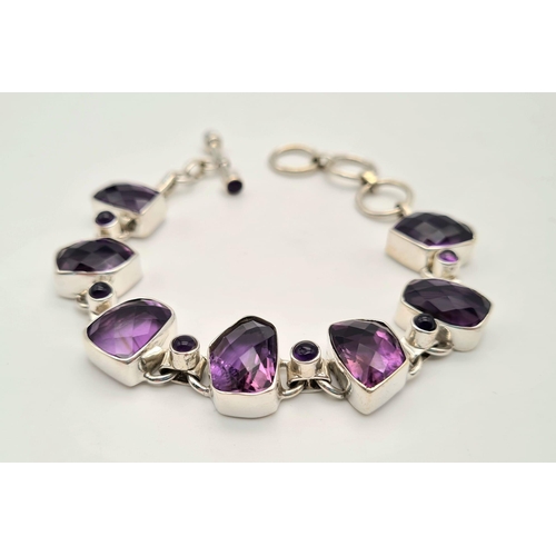 449 - A Fancy Shape Amethyst Gemstone Bracelet in 925 silver. 35g total weight. 19cm