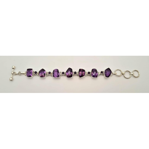 449 - A Fancy Shape Amethyst Gemstone Bracelet in 925 silver. 35g total weight. 19cm