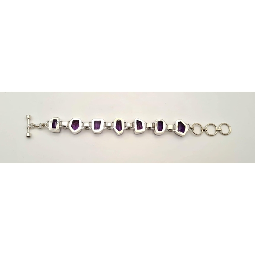 449 - A Fancy Shape Amethyst Gemstone Bracelet in 925 silver. 35g total weight. 19cm