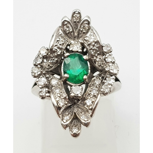 15 - An Antique Victorian 18K White Gold Emerald and Diamond Ring. A central Colombian oval cut emerald s... 