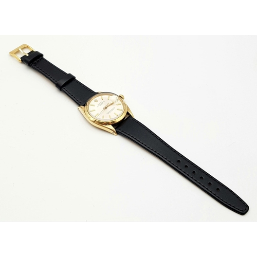 719 - A Rolex Oyster Perpetual Gold Cased Gents Watch. Black leather strap. 14K gold case - 35mm. White di... 