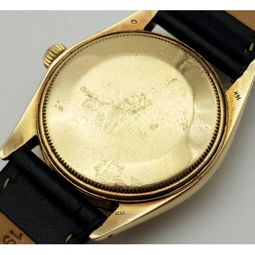 719 - A Rolex Oyster Perpetual Gold Cased Gents Watch. Black leather strap. 14K gold case - 35mm. White di... 