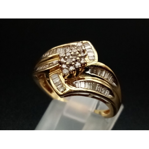 593 - A 10K Yellow Gold Diamond Double-Crossover Ring. Four baguette diamond bands meet in a central diamo... 