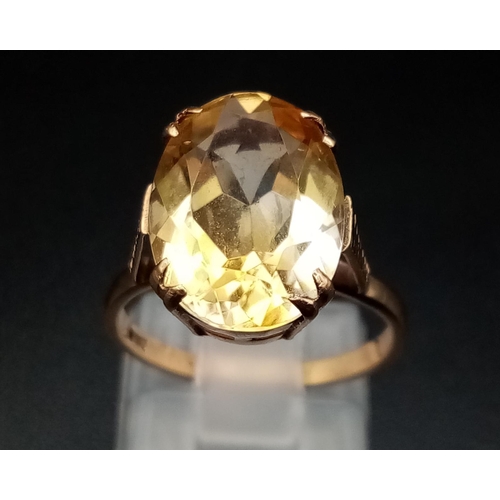 598 - A 9K yellow Gold Citrine Ring. A clean, faceted oval-cut central 5ct citrine completes this ring. Si... 