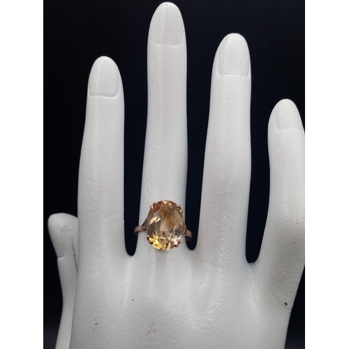 598 - A 9K yellow Gold Citrine Ring. A clean, faceted oval-cut central 5ct citrine completes this ring. Si... 