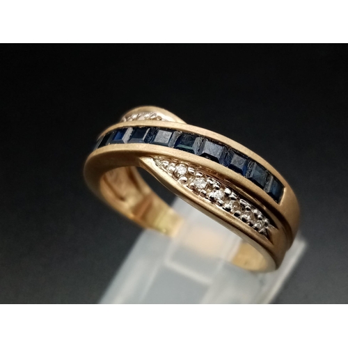 599 - A 14K Yellow Gold Diamond and Sapphire Crossover Ring. Eleven square-cut sapphires crossed over by a... 