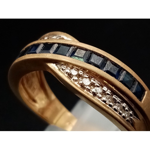 599 - A 14K Yellow Gold Diamond and Sapphire Crossover Ring. Eleven square-cut sapphires crossed over by a... 