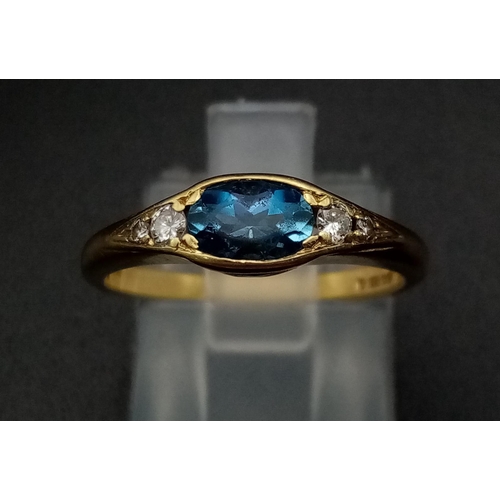 600 - An 18K Yellow Gold Ceylon Pale Blue Sapphire Diamond Ring. Central sapphire with two graduated round... 