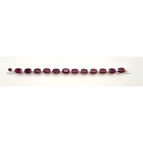 695 - An Oval Shape Ruby Gemstone Bracelet in 925 Silver. 27g total weight. 19cm.