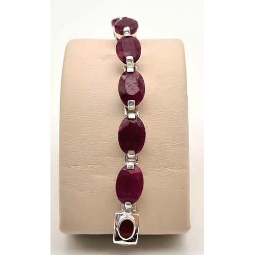 695 - An Oval Shape Ruby Gemstone Bracelet in 925 Silver. 27g total weight. 19cm.