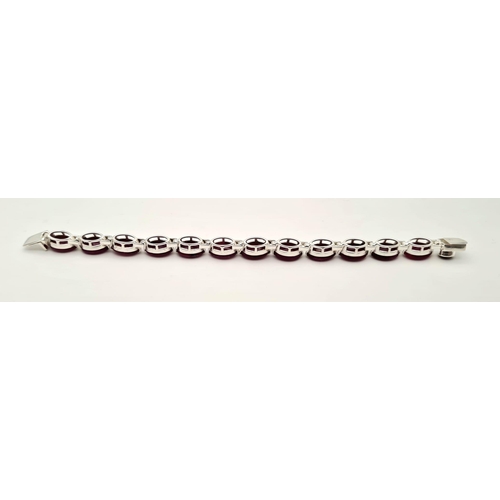 695 - An Oval Shape Ruby Gemstone Bracelet in 925 Silver. 27g total weight. 19cm.