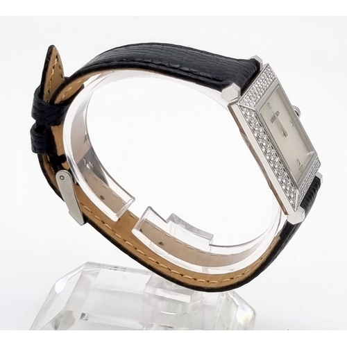 81 - A Boucheron 18K Gold and Diamond Ladies Watch. Black leather strap. Gold and diamond rectangular cas... 