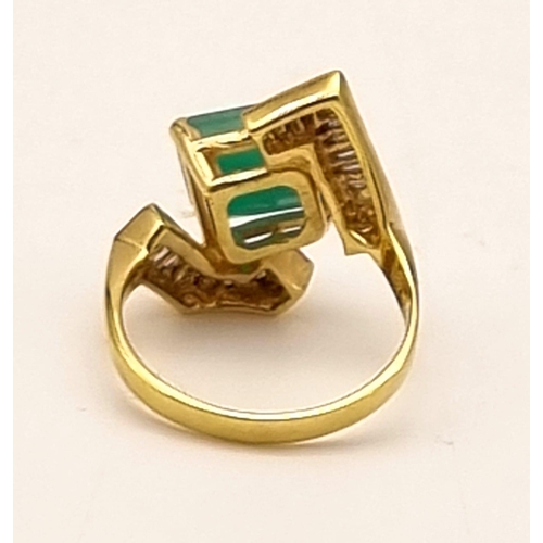 88 - An 18K Yellow Gold Emerald and Diamond Ring. Central cut natural emerald with 26 tapered baguette cu... 