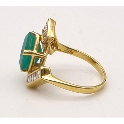 88 - An 18K Yellow Gold Emerald and Diamond Ring. Central cut natural emerald with 26 tapered baguette cu... 