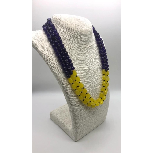 166 - A Dazzling Three-Strand Amethyst and Yellow Onyx Beaded Necklace. Round and oval beads. 46 - 52cm.