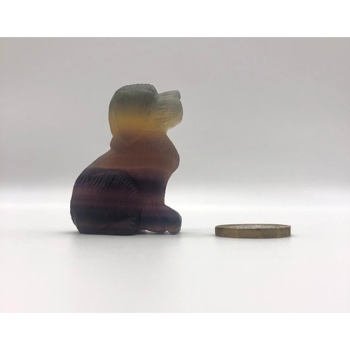 173 - A Rainbow Fluorite Crystal Small Dog Figure. 5 x 4cm