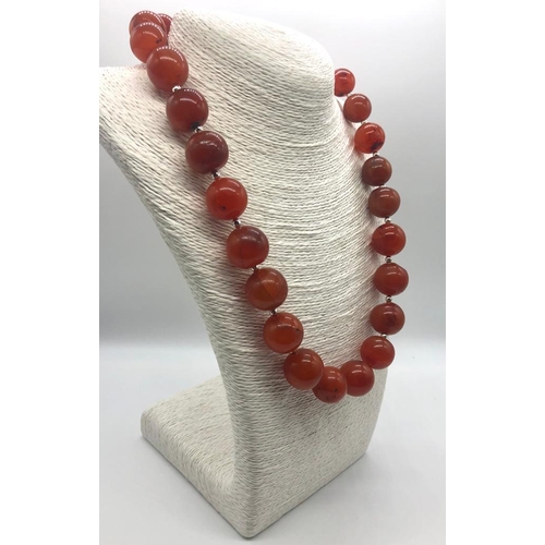 293 - An Autumn Fire Graduated Agate Bead Necklace. Largest bead 20mm.