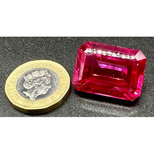 105 - A wonderful, large (57,06 carats), pinkish red RUBY. Emerald cut, flawless, with uniform colour dist... 