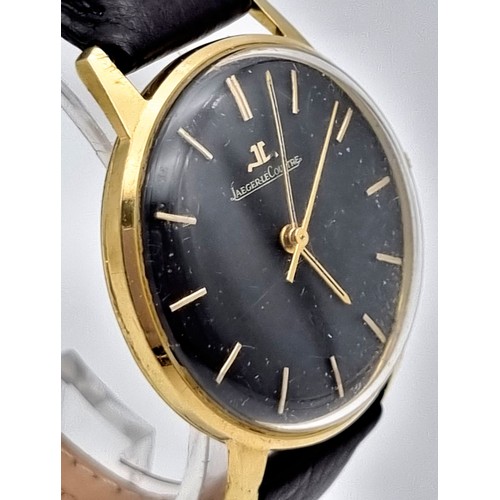 692 - A Vintage Jaeger Le Coultre 18K Gold Gents Watch. Black leather strap. Gold case - 35mm. Black dial ... 